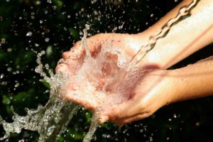The hands receiving the water