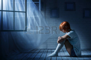 29528748-lonely-girl-sits-in-an-empty-dark-room-opposite-the-window